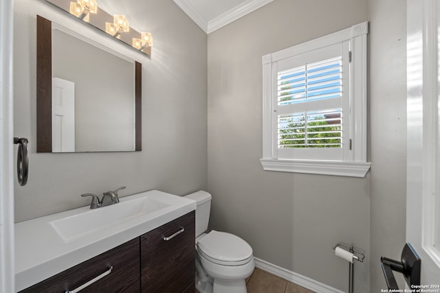 bathroom featuring vanity, toilet, ornamental molding, and tile patterned floors