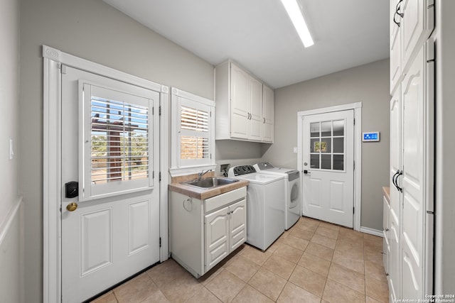 laundry room with cabinets, independent washer and dryer, sink, and light tile patterned flooring