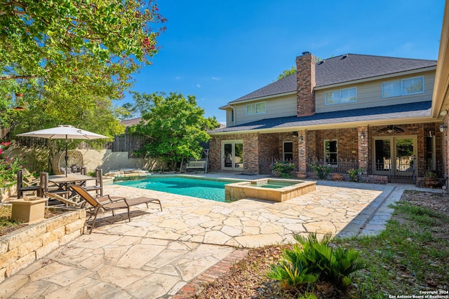 view of pool featuring a patio area and an in ground hot tub