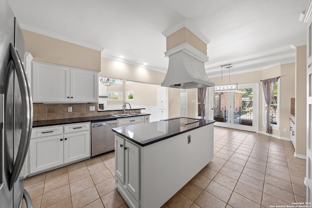 kitchen with appliances with stainless steel finishes, white cabinetry, and plenty of natural light