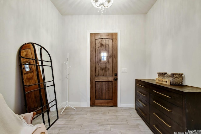 entrance foyer featuring light hardwood / wood-style floors and a notable chandelier