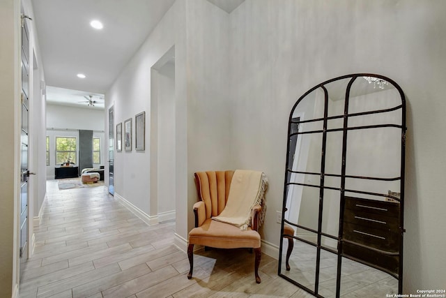 sitting room with light hardwood / wood-style flooring and ceiling fan