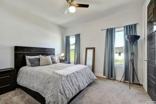 bedroom with a ceiling fan, carpet, multiple windows, and baseboards