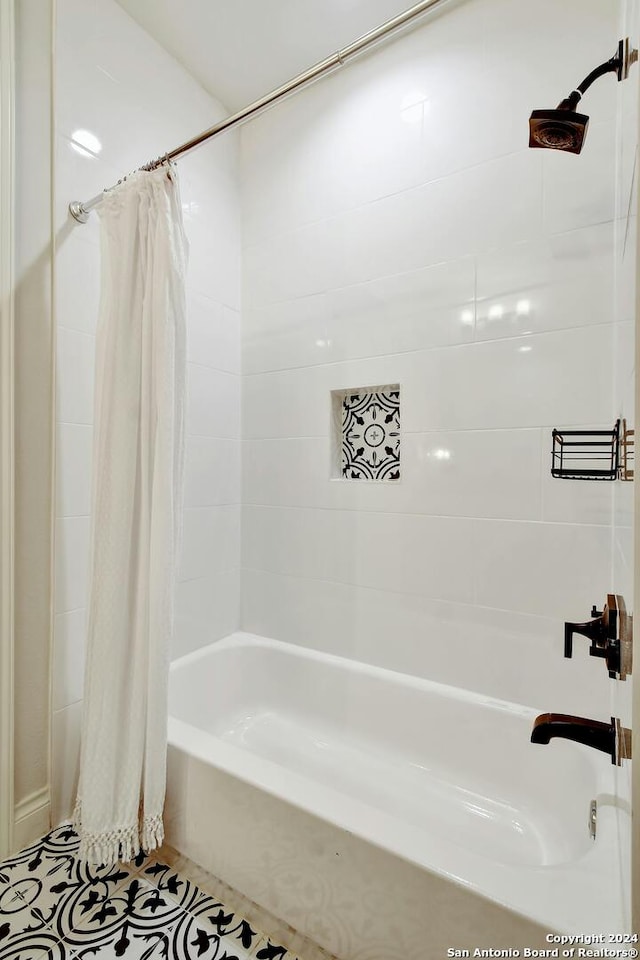 bathroom featuring tile patterned flooring and shower / bath combo