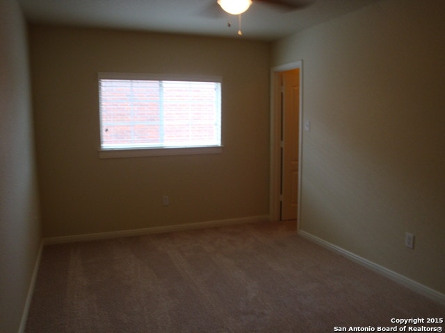 carpeted empty room with ceiling fan