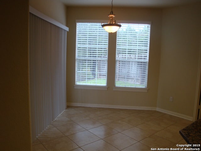 unfurnished dining area with light tile patterned floors