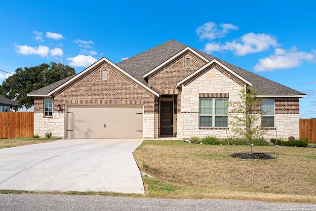 view of front of property featuring a garage and a front yard