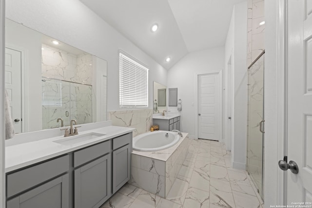 bathroom with vaulted ceiling, separate shower and tub, and vanity