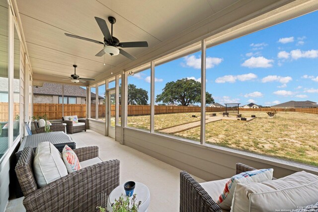 sunroom featuring plenty of natural light and ceiling fan