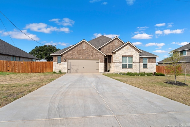 view of front of home featuring a garage and a front yard