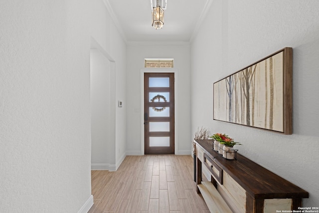 foyer with light hardwood / wood-style flooring and ornamental molding