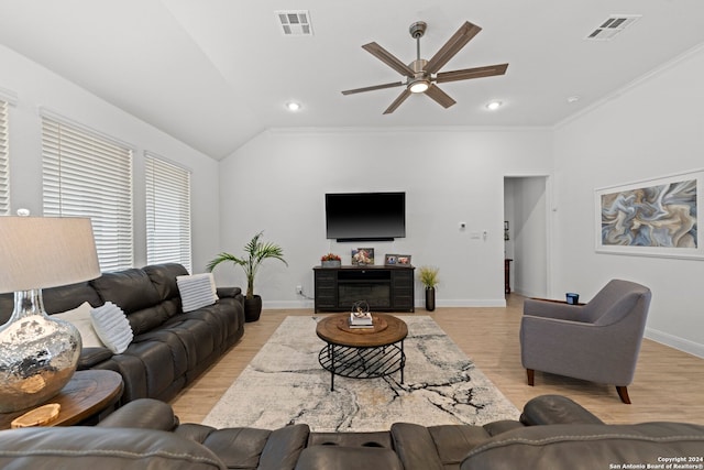 living room featuring light wood-type flooring, crown molding, lofted ceiling, and ceiling fan