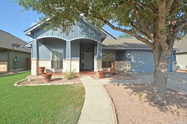 view of front of house featuring a garage, a front yard, and a porch