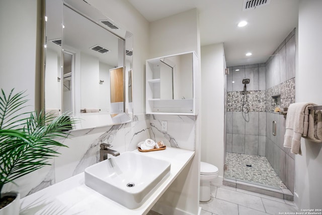 full bath featuring visible vents, a stall shower, toilet, and a sink