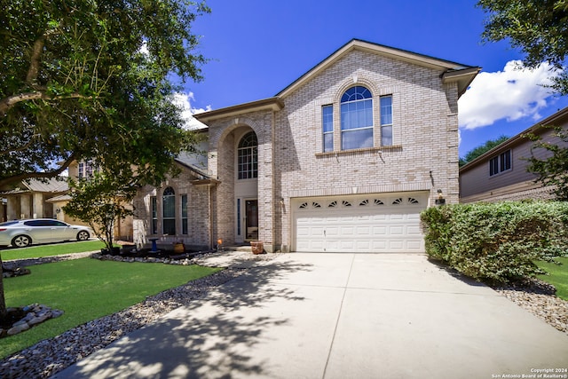 view of front of property with a front yard and a garage