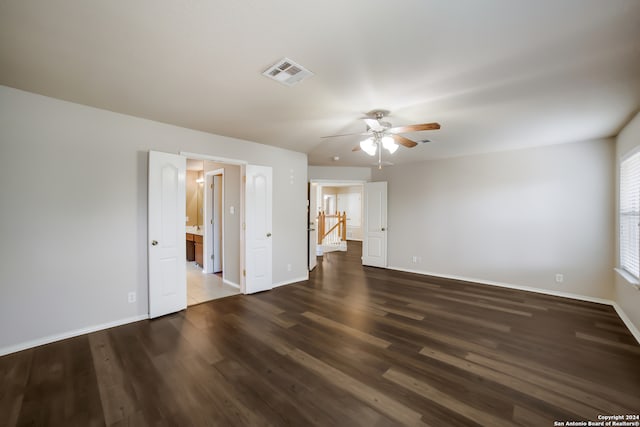 spare room with dark wood-type flooring and ceiling fan