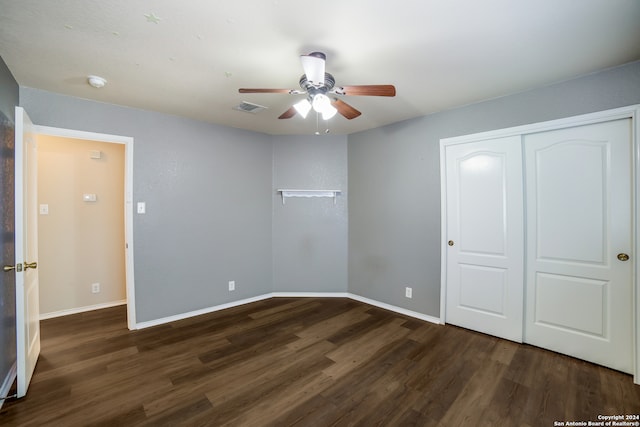 unfurnished bedroom featuring a closet, ceiling fan, and dark hardwood / wood-style floors