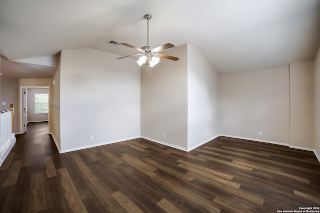 unfurnished room with ceiling fan, vaulted ceiling, and dark hardwood / wood-style flooring