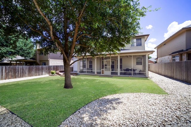 rear view of house with a patio, a sunroom, and a lawn