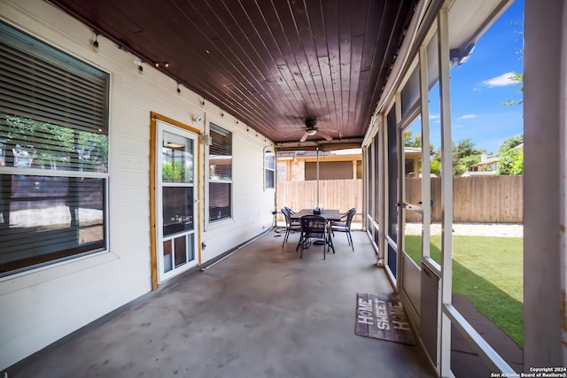 sunroom / solarium with wood ceiling and ceiling fan