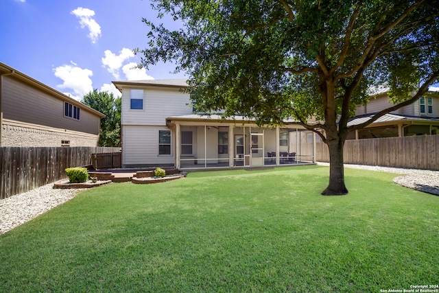 rear view of house featuring a patio, a yard, and a sunroom