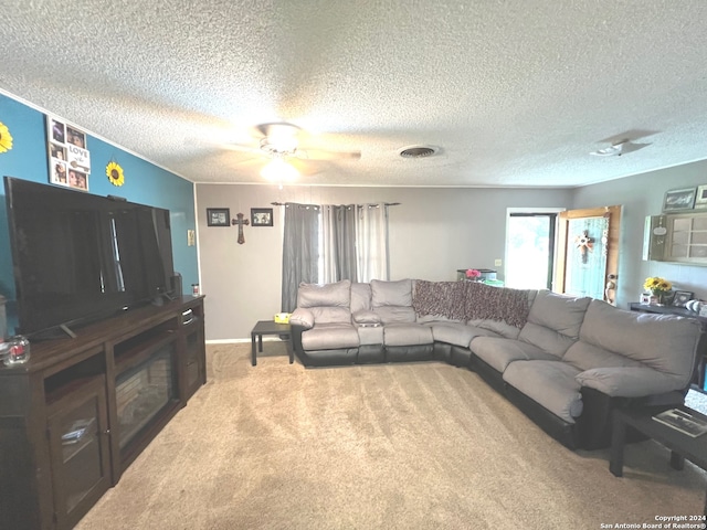 carpeted living room featuring a textured ceiling and ceiling fan