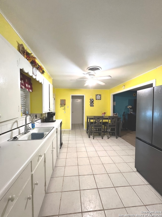 kitchen featuring light tile patterned flooring, ceiling fan, white cabinetry, and sink