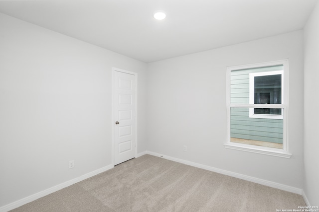 spare room with light carpet and a healthy amount of sunlight