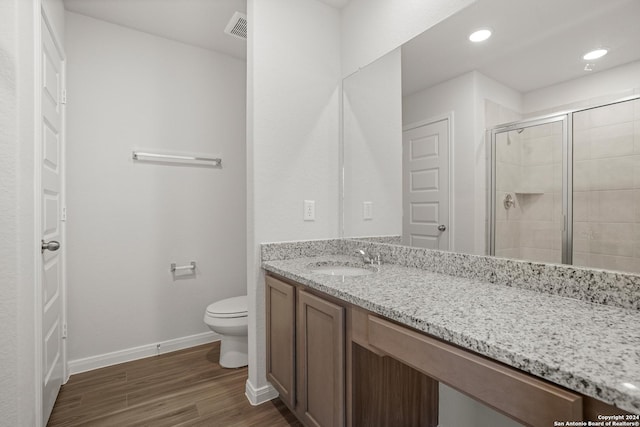 15055 Homing Mdw, San Antonio, TX 78253 - bathroom featuring toilet, a shower stall, vanity, wood finished floors, and baseboards