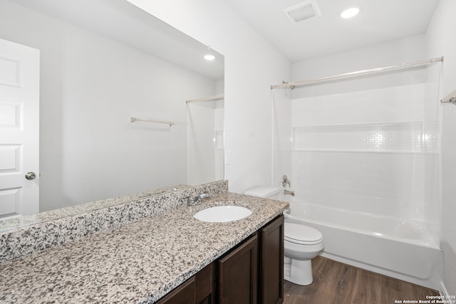 full bathroom with shower / bathtub combination, toilet, hardwood / wood-style flooring, and vanity