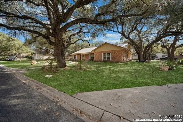 ranch-style home featuring a front lawn