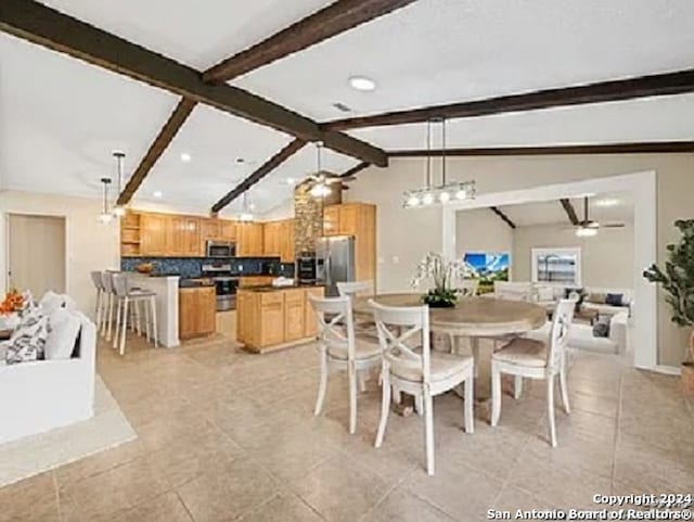 dining area with ceiling fan, lofted ceiling with beams, and light tile patterned floors