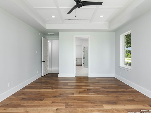 unfurnished bedroom featuring ceiling fan, wood-type flooring, and coffered ceiling