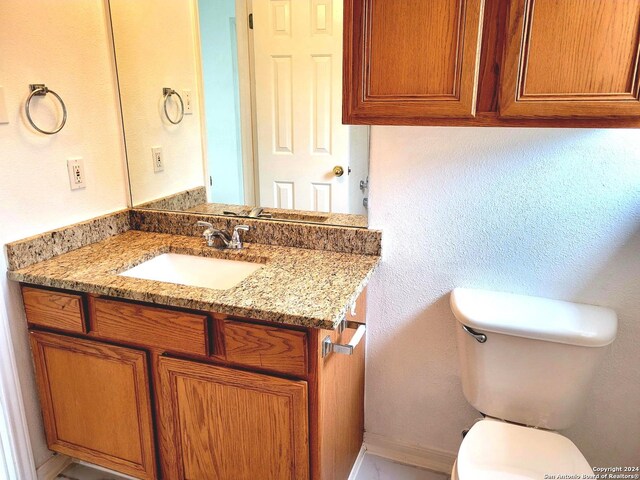 bathroom with vanity, toilet, and walk in shower