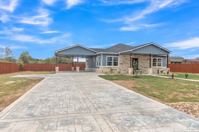 ranch-style home with a front yard and a carport