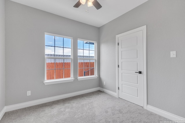 carpeted empty room with ceiling fan