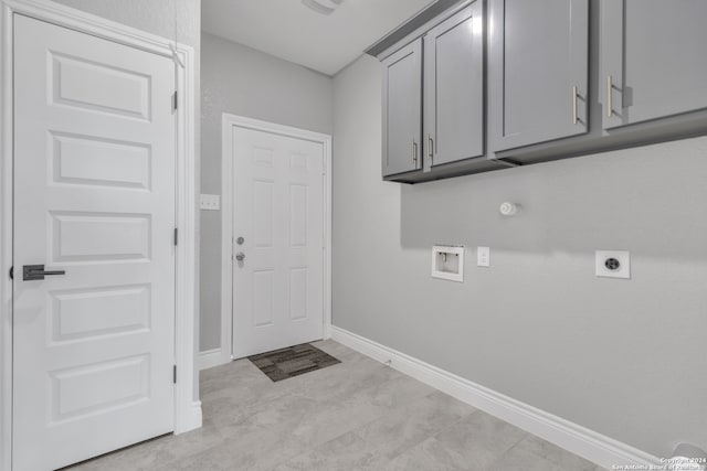 clothes washing area featuring hookup for a gas dryer, hookup for a washing machine, cabinets, and electric dryer hookup