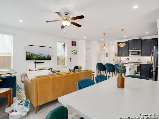 dining room featuring light wood-type flooring, a wealth of natural light, and ceiling fan