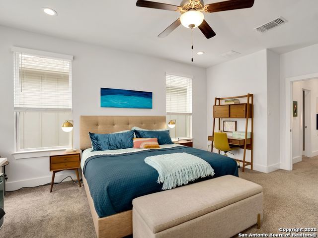 carpeted bedroom with ceiling fan