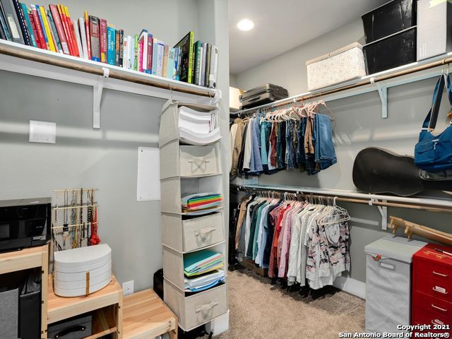 walk in closet featuring light carpet