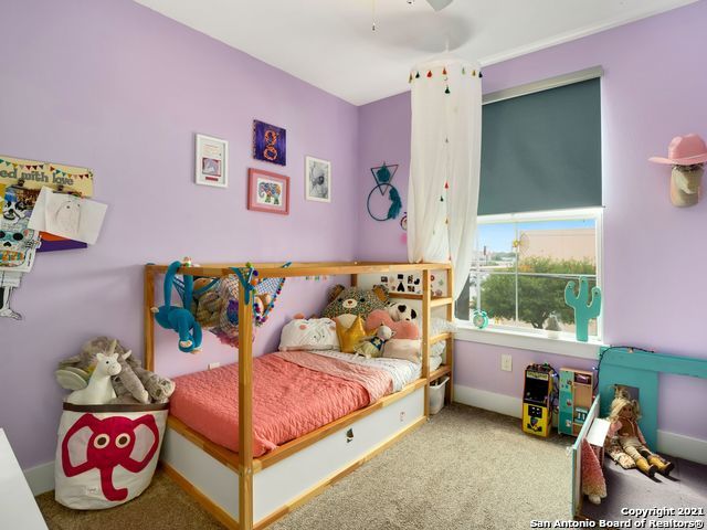 bedroom featuring ceiling fan and light colored carpet