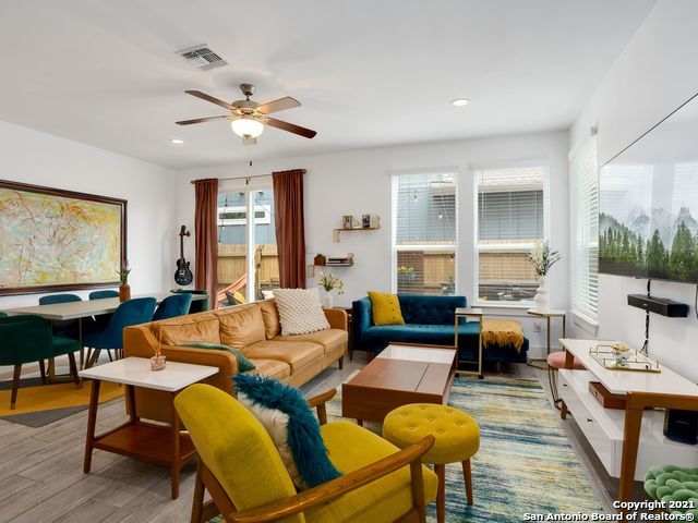 living room featuring ceiling fan and wood-type flooring