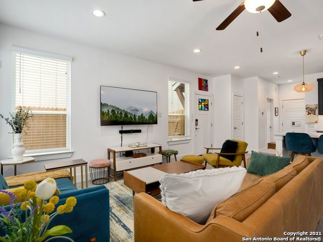 living room featuring ceiling fan and hardwood / wood-style flooring