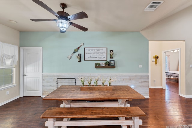 dining space with dark wood-type flooring, vaulted ceiling, and ceiling fan