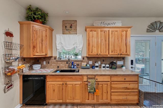 kitchen featuring black dishwasher, decorative backsplash, light tile patterned flooring, and sink