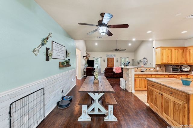 kitchen with hardwood / wood-style floors, lofted ceiling, light brown cabinets, ceiling fan, and decorative backsplash