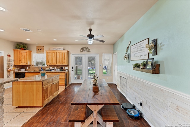 kitchen with a kitchen island, light hardwood / wood-style flooring, light brown cabinetry, sink, and ceiling fan