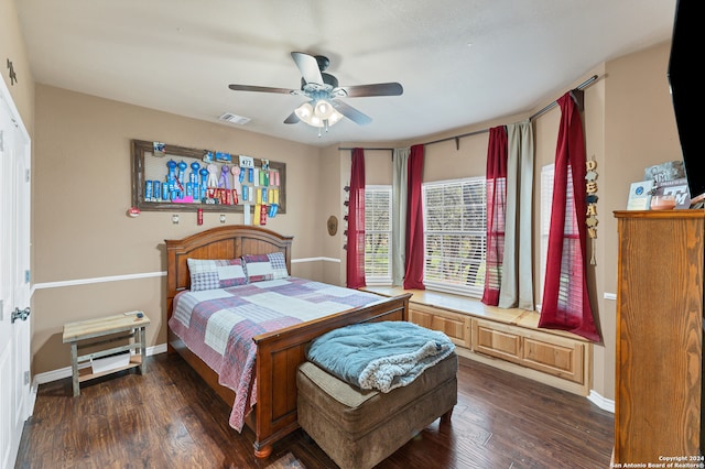 bedroom with ceiling fan and dark hardwood / wood-style flooring