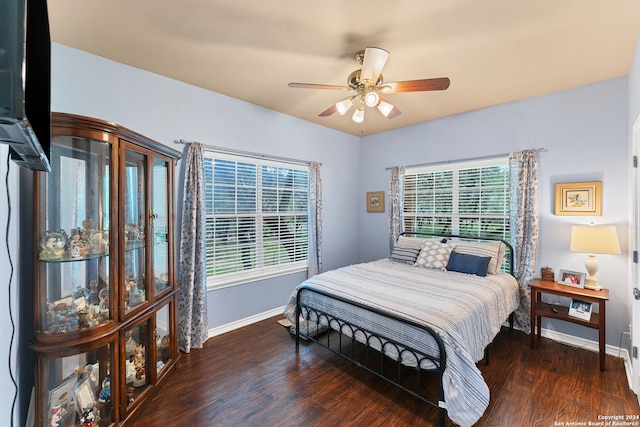 bedroom with ceiling fan and dark hardwood / wood-style floors