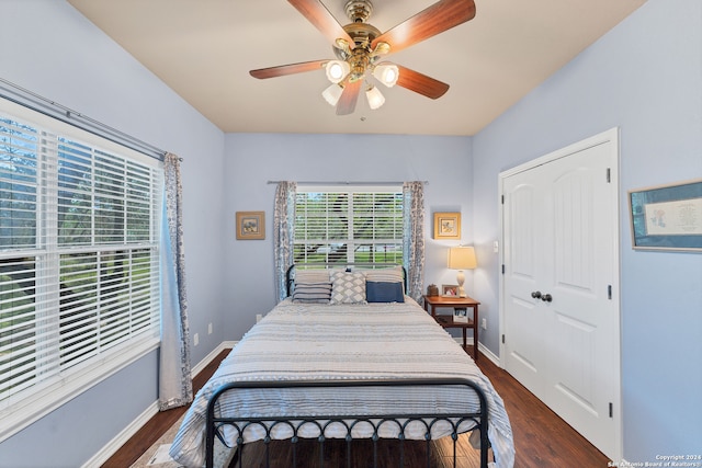 bedroom with dark wood-type flooring and ceiling fan